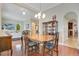 Bright dining room featuring hardwood floors, a chandelier, and views into the living room and kitchen at 1636 Hanks Ave, Orlando, FL 32814