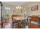 Dining room with wood floors, a large window, and a mirror, creating an elegant space for meals at 1636 Hanks Ave, Orlando, FL 32814