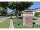 Inviting Baldwin Park entrance with brick signage and lush landscaping on a sunny day at 1636 Hanks Ave, Orlando, FL 32814