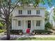 Charming two-story home featuring red tile roof, classic white pillars, and manicured landscaping at 1636 Hanks Ave, Orlando, FL 32814
