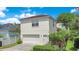 Charming two-story home with a tile roof, attached garage, and beautifully landscaped front yard at 1636 Hanks Ave, Orlando, FL 32814