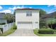Charming two-story home with a well-manicured lawn, white picket fence, and attached garage at 1636 Hanks Ave, Orlando, FL 32814