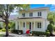 Stunning two-story home featuring red tile roof, classic white pillars, and manicured landscaping at 1636 Hanks Ave, Orlando, FL 32814