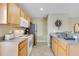 Kitchen with wood cabinets, stainless steel refrigerator, microwave, and neutral countertops at 1636 Hanks Ave, Orlando, FL 32814