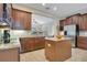 Gourmet kitchen features granite countertops, stainless steel appliances, and rich wood cabinetry at 1636 Hanks Ave, Orlando, FL 32814