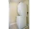 Efficient laundry area featuring a stacked washer and dryer set, maximizing space in a compact design at 1636 Hanks Ave, Orlando, FL 32814