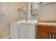 Functional laundry room featuring modern appliances and ample counter space for folding at 1636 Hanks Ave, Orlando, FL 32814