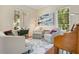 Comfortable living room with large windows, stylish seating, and hardwood floors at 1636 Hanks Ave, Orlando, FL 32814