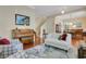 Open-concept living room and dining area with hardwood floors, piano and ample natural light at 1636 Hanks Ave, Orlando, FL 32814