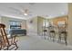 Open living space with bedroom, breakfast bar, kitchenette, rocking chair, and ceiling fan at 1636 Hanks Ave, Orlando, FL 32814