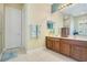 Main bathroom featuring a dual sink vanity with wood cabinets and tile flooring at 1636 Hanks Ave, Orlando, FL 32814