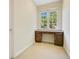 Cozy office nook with custom built-in desk, cabinet storage, and a large window at 1636 Hanks Ave, Orlando, FL 32814