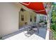 Charming patio with shaded seating, ideal for outdoor dining and enjoying the serene surroundings of the home at 1636 Hanks Ave, Orlando, FL 32814