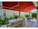 The shaded patio features comfortable seating, a dining table, and lush landscaping for outdoor enjoyment at 1636 Hanks Ave, Orlando, FL 32814