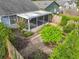 Aerial view of a screened-in patio overlooking landscaped backyard and garden at 1751 Chatham Cir, Apopka, FL 32703