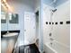 Bathroom featuring combination tub/shower, sleek black tile floors, and contemporary fixtures at 1751 Chatham Cir, Apopka, FL 32703