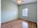 Bedroom features light green walls, wood-look floors, and a window for natural light at 1751 Chatham Cir, Apopka, FL 32703