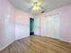 Bedroom with hardwood floors, ceiling fan, and closet; perfect for a cozy retreat at 1751 Chatham Cir, Apopka, FL 32703