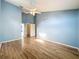 Spacious bedroom boasts vaulted ceilings, light blue walls, wood-look flooring and view of the closet at 1751 Chatham Cir, Apopka, FL 32703