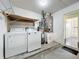 Laundry room with washer, dryer, shelves and utility sink; conveniently located for everyday tasks at 1751 Chatham Cir, Apopka, FL 32703