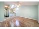 Inviting living room features wood floors, an open floor plan, natural light, and a view of the kitchen at 1751 Chatham Cir, Apopka, FL 32703
