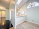 Open concept living space featuring black tile, wood flooring, kitchen view, and natural light at 1751 Chatham Cir, Apopka, FL 32703