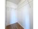 Walk-in closet with wood-look floors and wire shelving for storage at 1751 Chatham Cir, Apopka, FL 32703