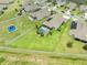 A gorgeous aerial view features a private pool, lush landscaping, and a large fenced yard at 1789 Chatsworth Cir, St Cloud, FL 34771