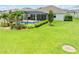 Lush backyard showcasing a screened-in pool area with mature landscaping, ideal for outdoor living at 1789 Chatsworth Cir, St Cloud, FL 34771