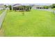 Manicured backyard with a beautiful lawn featuring a small tree in the center of the space at 1789 Chatsworth Cir, St Cloud, FL 34771