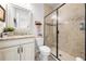 Bathroom boasts a granite countertop vanity and glass-enclosed tiled shower at 1789 Chatsworth Cir, St Cloud, FL 34771