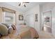 Comfortable bedroom with ceiling fan and view into office area through doorway at 1789 Chatsworth Cir, St Cloud, FL 34771