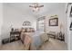 Comfortable bedroom featuring a ceiling fan, decorative accents, and carpet flooring at 1789 Chatsworth Cir, St Cloud, FL 34771