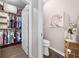 Walk-in closet with custom shelving and ample storage space, adjacent to a convenient half-bathroom at 1789 Chatsworth Cir, St Cloud, FL 34771