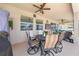 Relaxing covered patio featuring ceiling fans and an outdoor dining set for comfortable outdoor living at 1789 Chatsworth Cir, St Cloud, FL 34771
