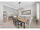 Open dining area with a rustic wood table, chandelier, and natural light at 1789 Chatsworth Cir, St Cloud, FL 34771