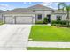 Charming single-story home with a well-manicured lawn and a spacious three-car garage at 1789 Chatsworth Cir, St Cloud, FL 34771