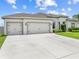 A beautiful one-story home with well-manicured landscaping and a spacious three-car garage at 1789 Chatsworth Cir, St Cloud, FL 34771