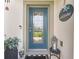 A charming front entrance with a blue door, welcome sign, and stylish decor at 1789 Chatsworth Cir, St Cloud, FL 34771