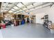 Well-organized garage with ample storage solutions, including shelving and space for multiple vehicles at 1789 Chatsworth Cir, St Cloud, FL 34771