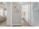 Hallway features doors to rooms and stylish flooring and decorative Gathering wall art at 1789 Chatsworth Cir, St Cloud, FL 34771