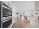 Spacious kitchen with stainless steel double oven and views of the open-concept living area at 1789 Chatsworth Cir, St Cloud, FL 34771