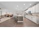 Open-concept kitchen with stainless steel appliances, island seating, and modern finishes at 1789 Chatsworth Cir, St Cloud, FL 34771