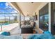 The lanai features cozy outdoor seating and a view of the pool and manicured landscaping at 1789 Chatsworth Cir, St Cloud, FL 34771