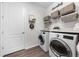 Laundry room features a modern washer and dryer in a bright space at 1789 Chatsworth Cir, St Cloud, FL 34771