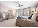 Spacious main bedroom featuring a ceiling fan, neutral carpet, and decorative accents for a serene ambiance at 1789 Chatsworth Cir, St Cloud, FL 34771