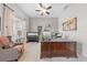 A spacious home office features a large desk, comfortable seating, and natural light at 1789 Chatsworth Cir, St Cloud, FL 34771