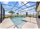 Sparkling screened-in pool with a sun deck, surrounded by tropical landscaping, perfect for outdoor enjoyment at 1789 Chatsworth Cir, St Cloud, FL 34771