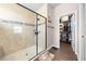 Walk-in shower featuring decorative tilework and glass enclosure, seamlessly connecting to walk-in closet at 1789 Chatsworth Cir, St Cloud, FL 34771