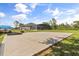 Spacious backyard featuring a large concrete pad with a screened-in pool in the background at 18826 Reynolds Pkwy, Orlando, FL 32833